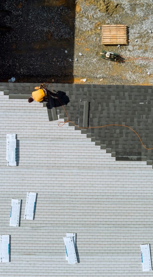 roofer-hands-installing-asphalt-shingles-on-house-2023-11-27-04-51-52-utc-2-scaled.jpg