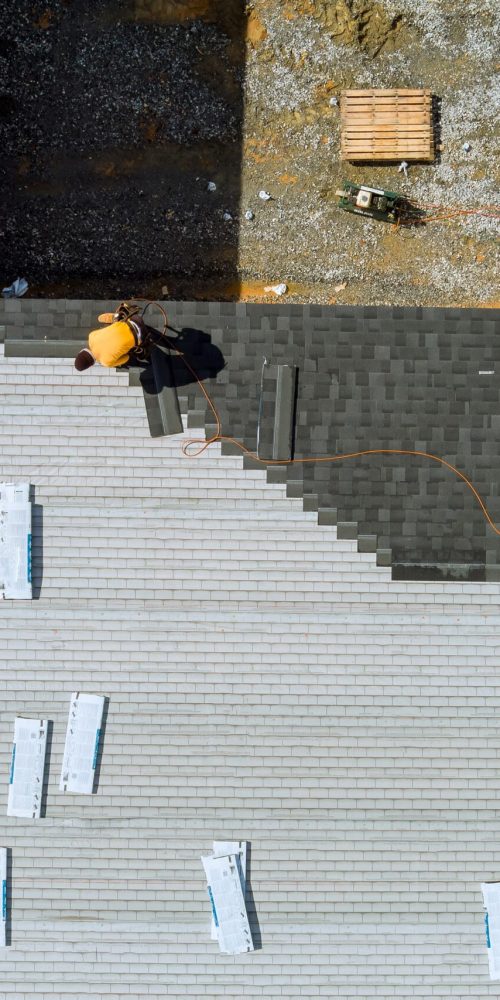 roofer-hands-installing-asphalt-shingles-on-house-2023-11-27-04-51-52-utc-2-scaled.jpg